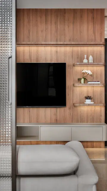 Checkered glass sliding doors flank the TV wall — when open, they reveal the apartment’s full depth, enhancing light and space.