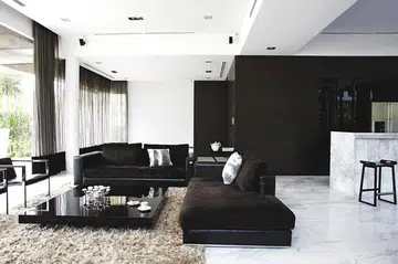 Wood veneer-clad walls ground the bare white open-concept living room in this 2.5 storey bungalow in Sentosa Cove. The solid marble bar counter blends so well with the floor, it looks like it was carved out of it.