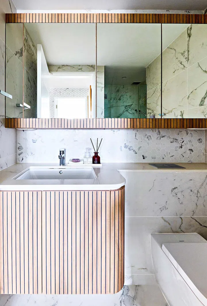Rounded curves along the bathroom counter make the space feel sensual and warm.