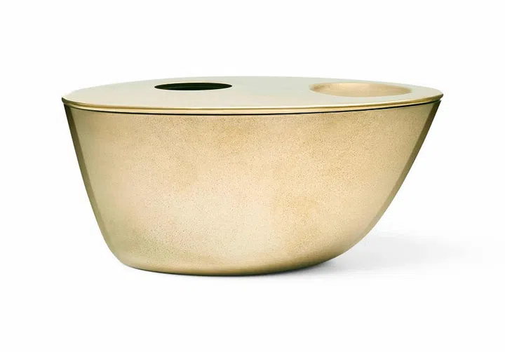 The Aesop brass oil burner sports an asymmetrical shape