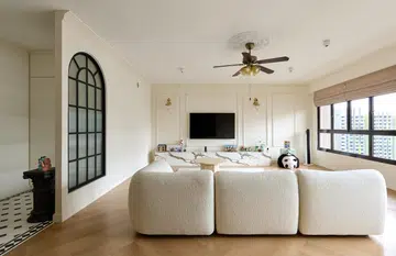 A snapshot the dining area leading to the living room. Wall sconces are used throughout the home. 