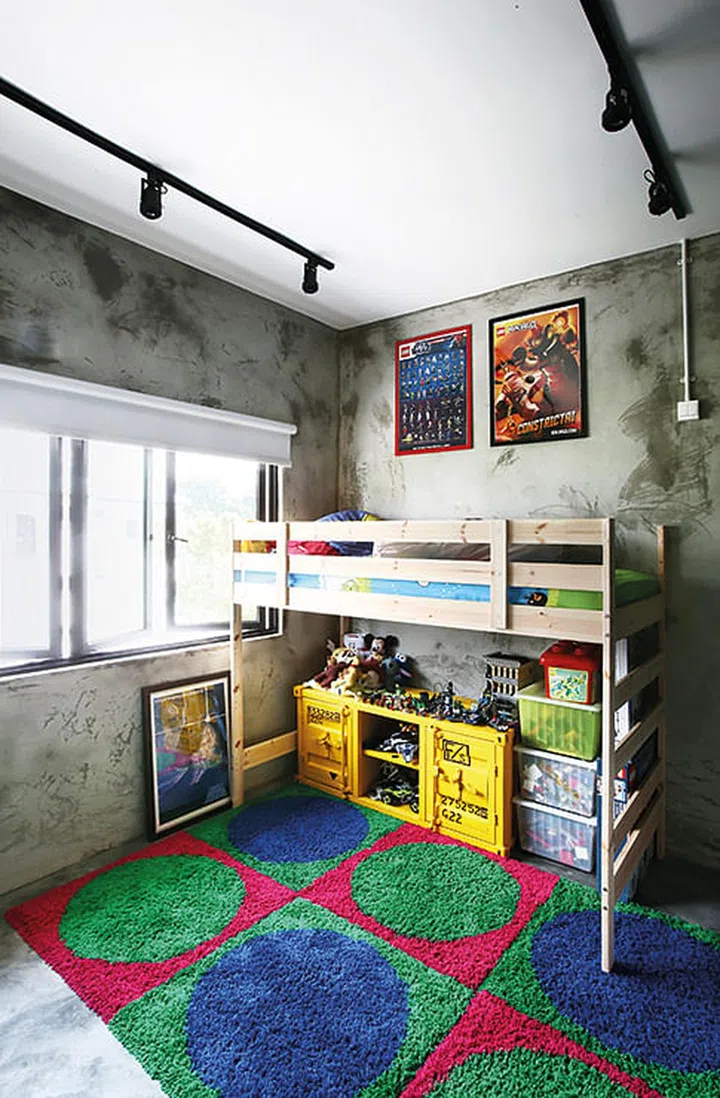 The son’s room gets a playful look from the colourful, geometric carpet. Interior design by 19sixtyseven