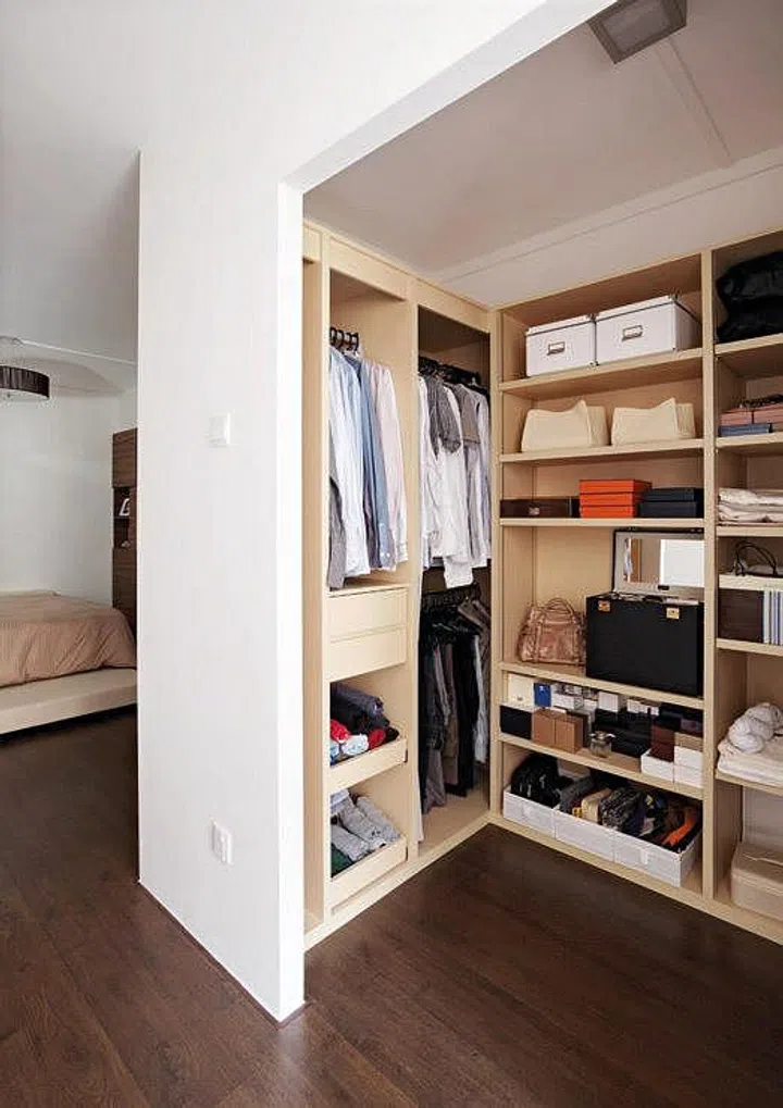 With adjustable shelves, the wardrobe seems made-to-measure for the storage boxes the couple uses to organise their knick-knacks.