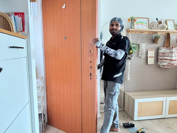 PRISM+ door lock installer uninstalling the old digital locks.