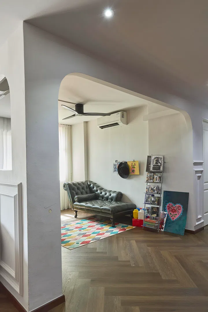 An arched opening defines the fourth bedroom, keeping it visually connected to the living area while setting it apart as a workspace.