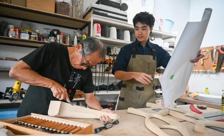 Tyrus Hong and his grandfather Tan Cheng Whatt inspire each other when they work in Tan’s home carpentry workshop. A Medusa figurine, fashioned by Tan, is a mini-monument to his grit and inventiveness with furniture-making.