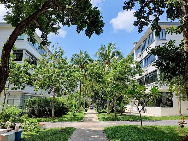 Image of low-rise residential apartment buildings amongst greenery. Image Unsplash.