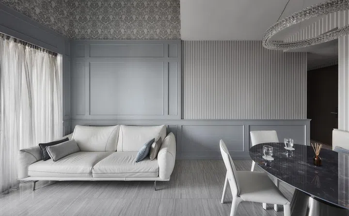 White leather sofa in a flight steward's 2-bedroom with study condominium along Sims Drive designed by The Cottage Crafts.