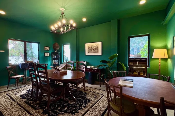 Windows boast tranquil garden views in The Green Room, where the spacious dining setups feature open picture books that invite you to sit, flip through the pages, and embrace slow hosting.