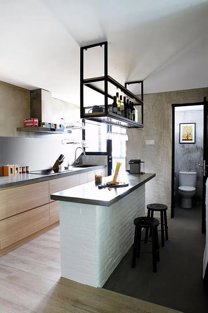 The kitchen island serves as a breakfast counter or food preparation table.
