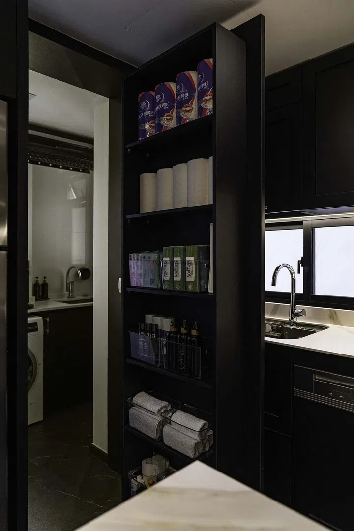 A hidden door that leads to a utility and laundry room in a banking couple's 3-bedroom condominium in West Coast.