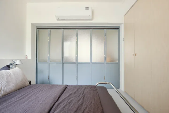 The accordion door closes fully to shield his private quarters from the living and dining spaces while hosting guests.