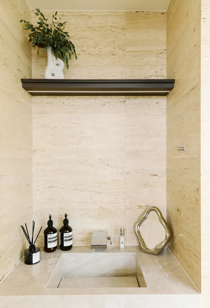 Custom stone basins in the master bathroom reflect a resort-like ambience, combining form and function with luxurious minimalism.