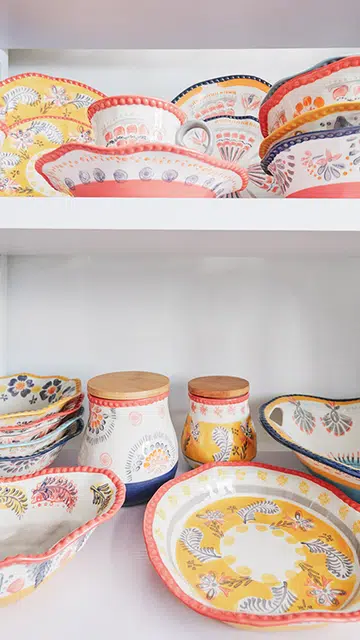 Eclectic, Mediterranean-style plates and jars at Lovera Collections.