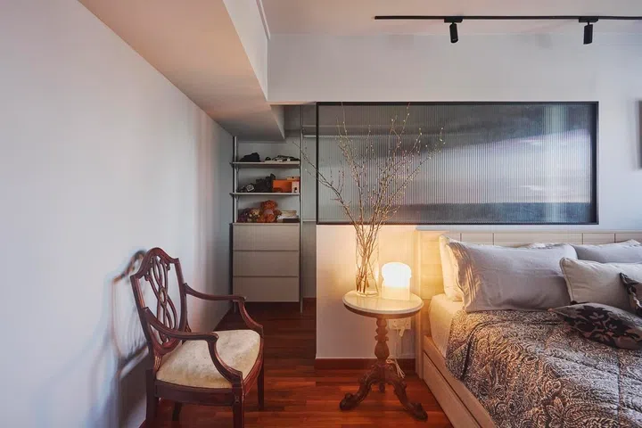 The master bedroom remains intentionally pared back, with natural light, warm timber flooring and carefully chosen furnishings creating a calm retreat.