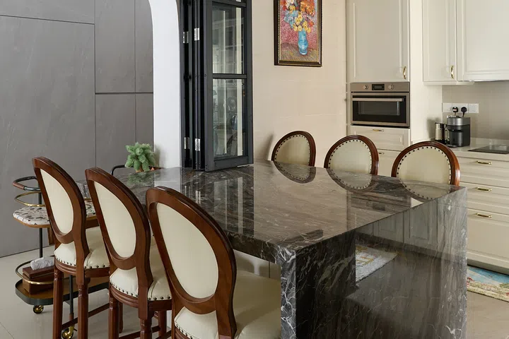 The $5,000 marble island uses one slab for continuous veining along its waterfall edge.