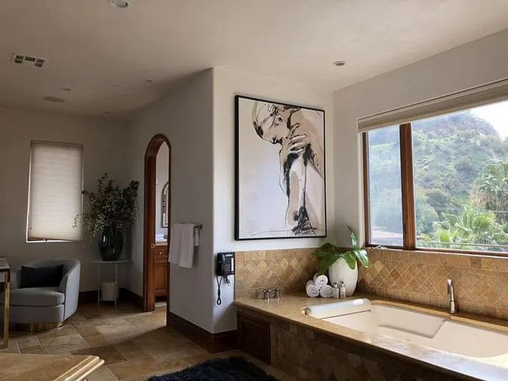 In Eva Longoria's Hollywood house, the tiled bathroom overlooks the lush canopy surrounding the private neighbourhood of Hollywood Dell.