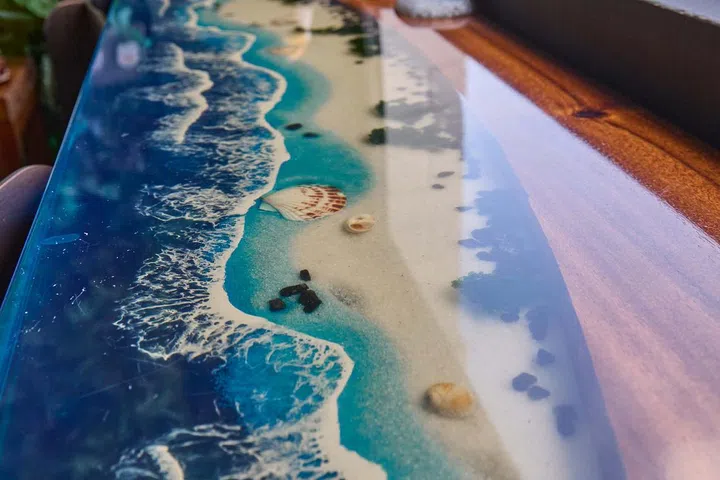 A resin counter table featuring a beach seascape in the balcony of a HDB Executive Maisonette in Pasir Ris.