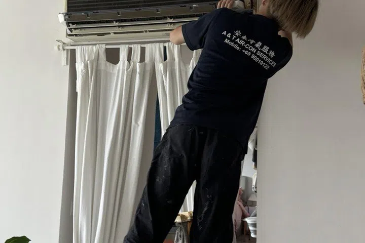 Coolfix air conditioner servicing technician at work.