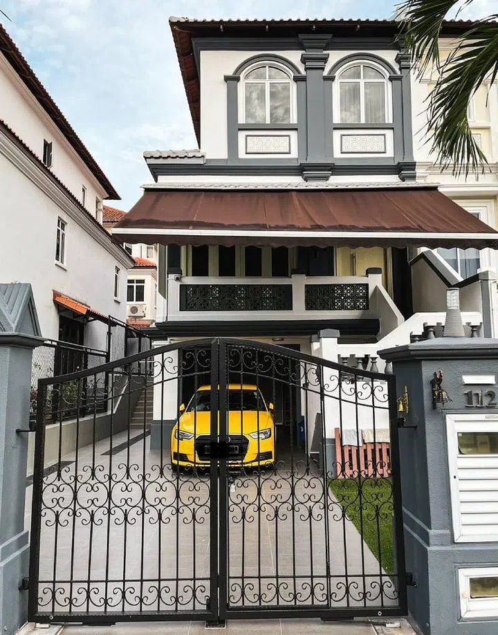 A yellow car parked within the driveway of a terrace house along Loyang Villas. Image StackedHomes.