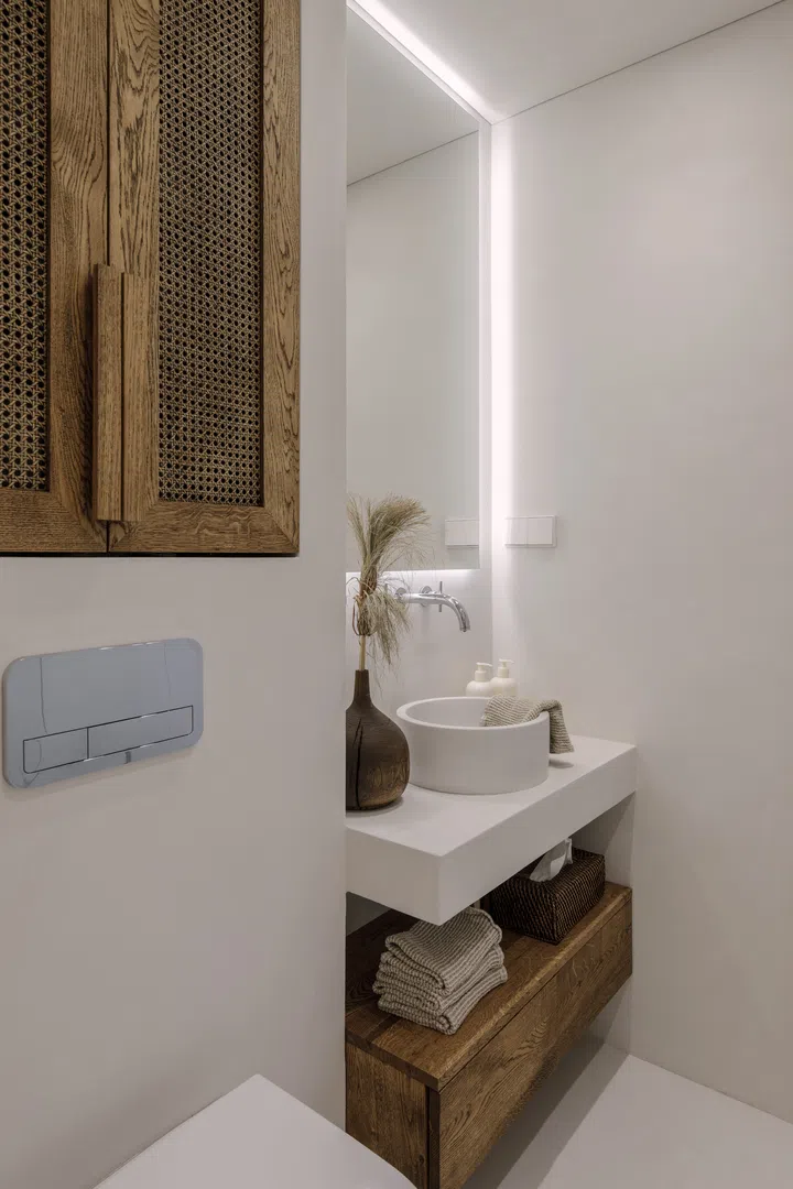 Aesthetic wabi sabi bathroom interior design in brown and off white shades with solid oak and rattan furniture. Microcement in bathroom. Slow living concept