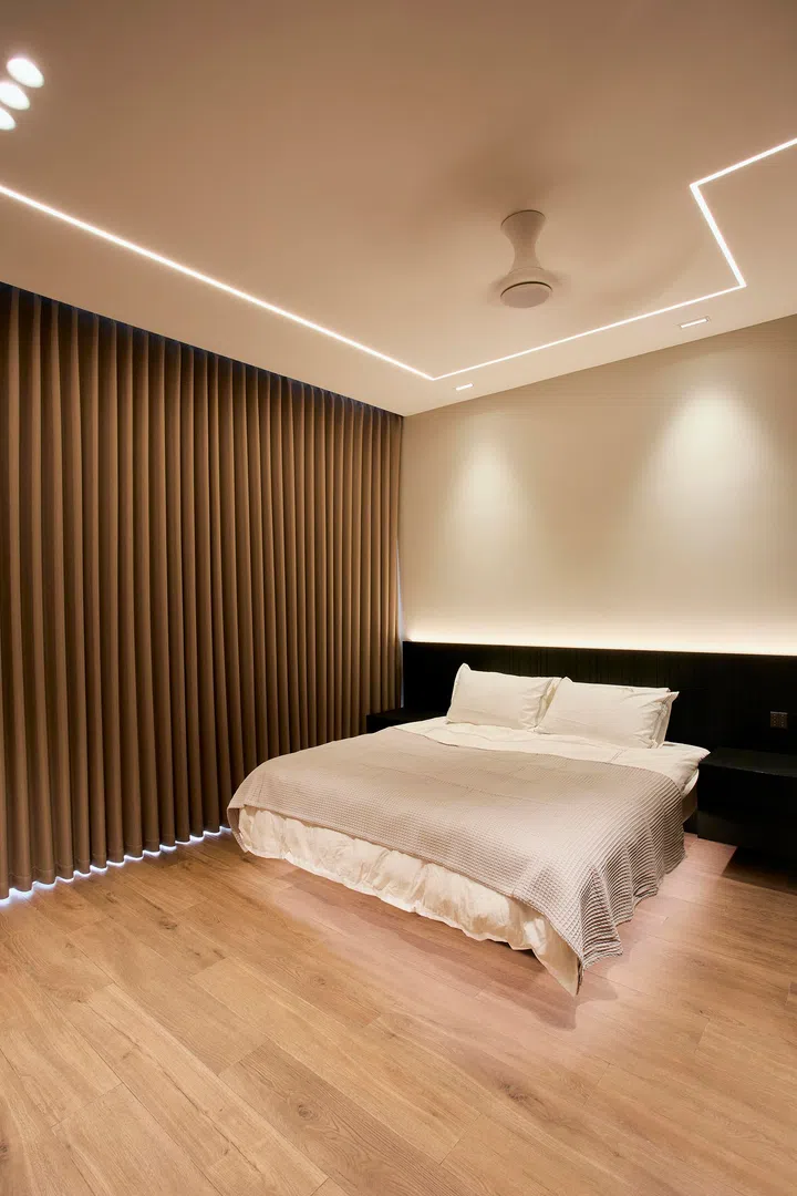 The bedroom is kept deliberately restrained, with soft lighting and a pared-back palette for rest and privacy.