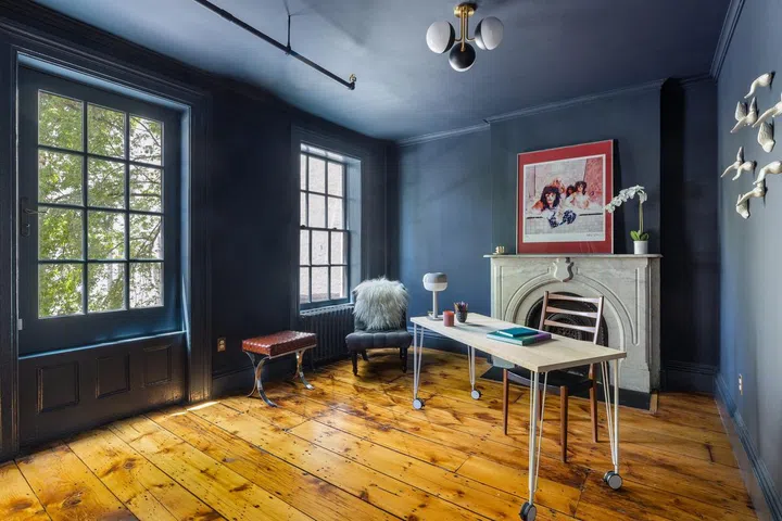 Deep blue walls in a study room with polished parquet wooden flooring. Home Staging and Home Styling by Staged to Sell Home. Photo by Hayley Ellen Day / DDReps