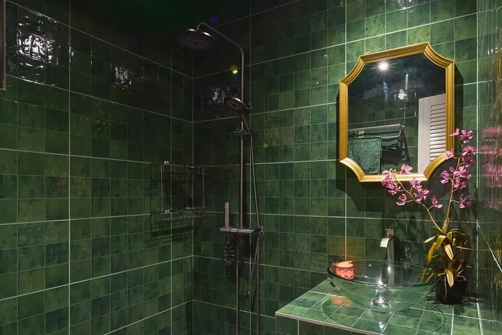 Tiles wrap every surface, allowing tonal variation and simple fittings to define the space.