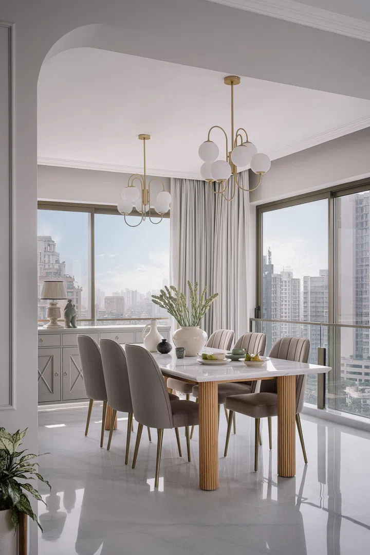 Dining room with floor-to-ceiling glass windows in this 2-bedroom apartment in Parsi, Mumbai.