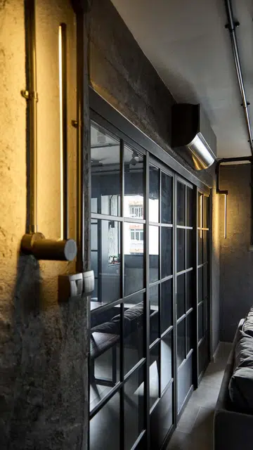 Sliding glass doors separate the kitchen and dining room from the living area in flight attendant Kenny Shoo’s  3-room HDB flat at Tampines Street 41.