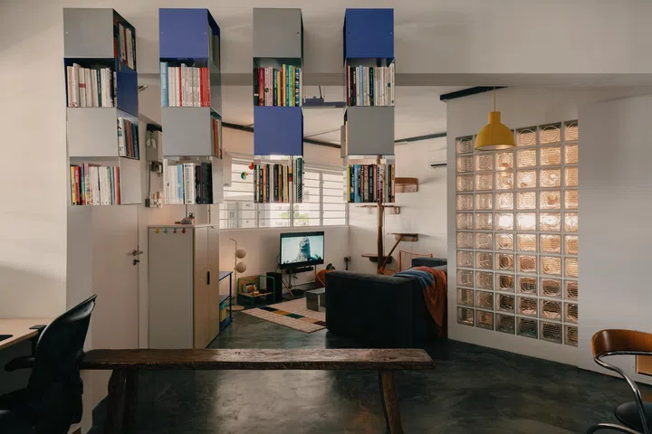 Floating bookshelves sectioning off the living room.