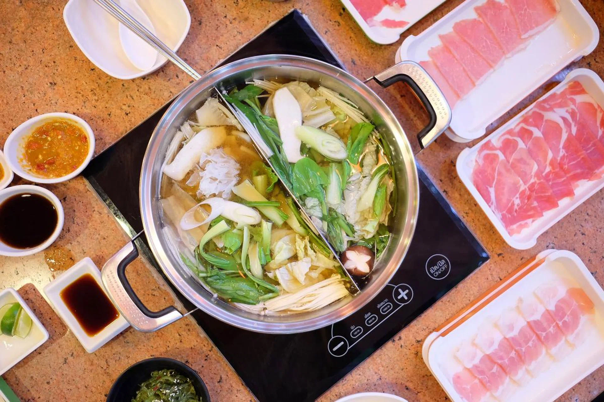 Top view of Shabu shabu boiled pot with meat and all ingredient in restaurant. Photo from 123RF