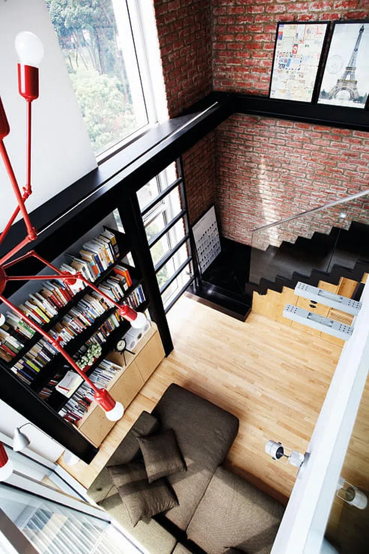The towering ceiling was enhances with brickwork and metal beams. An Octopus lamp from Autoban adds industrial chic.