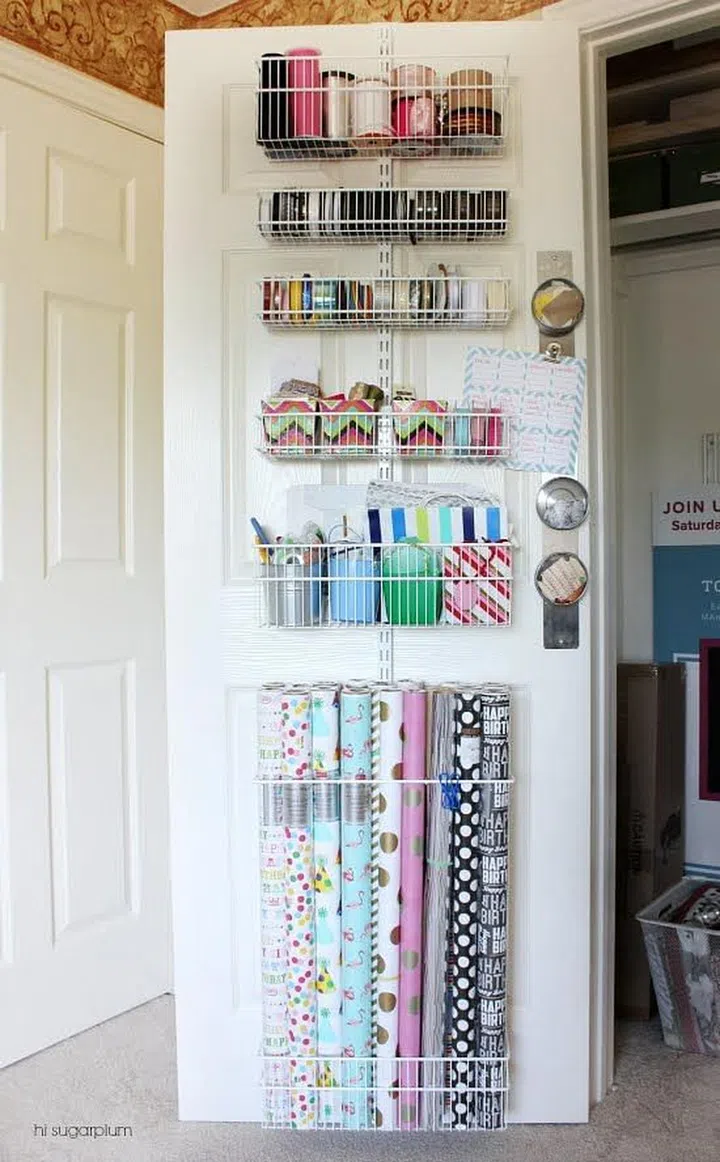 Store paper bags and rolls of wrapping paper in racks behind a door. Image by Hi Sugarplum