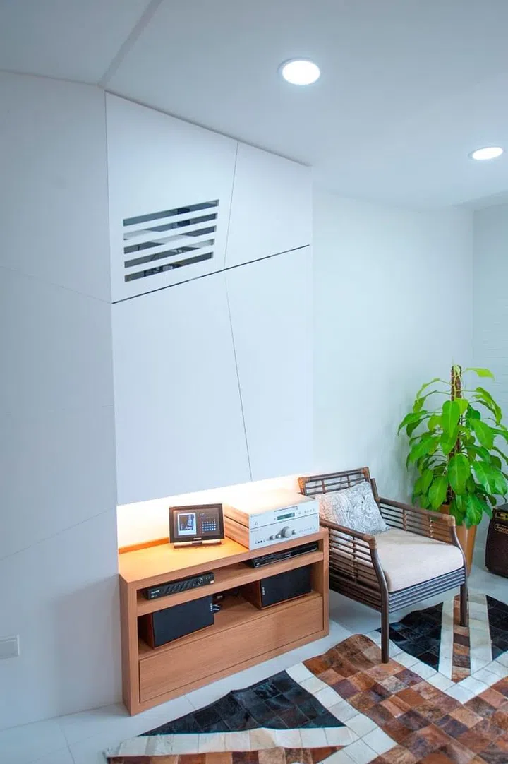 An angled laminate wall for the TV cabinetry and a slanted false ceiling