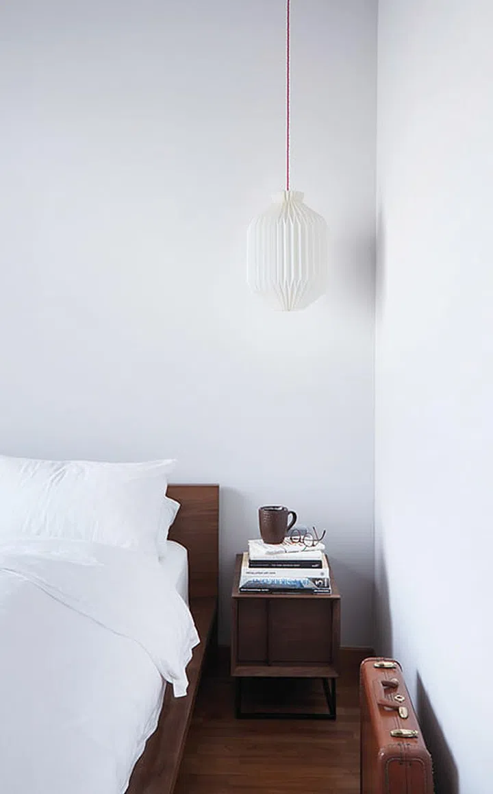 The master bedroom displays a complete contrast of colour tones compared to the living and dining areas. The furniture is from Grafunkt and the lamp, Pomelo.