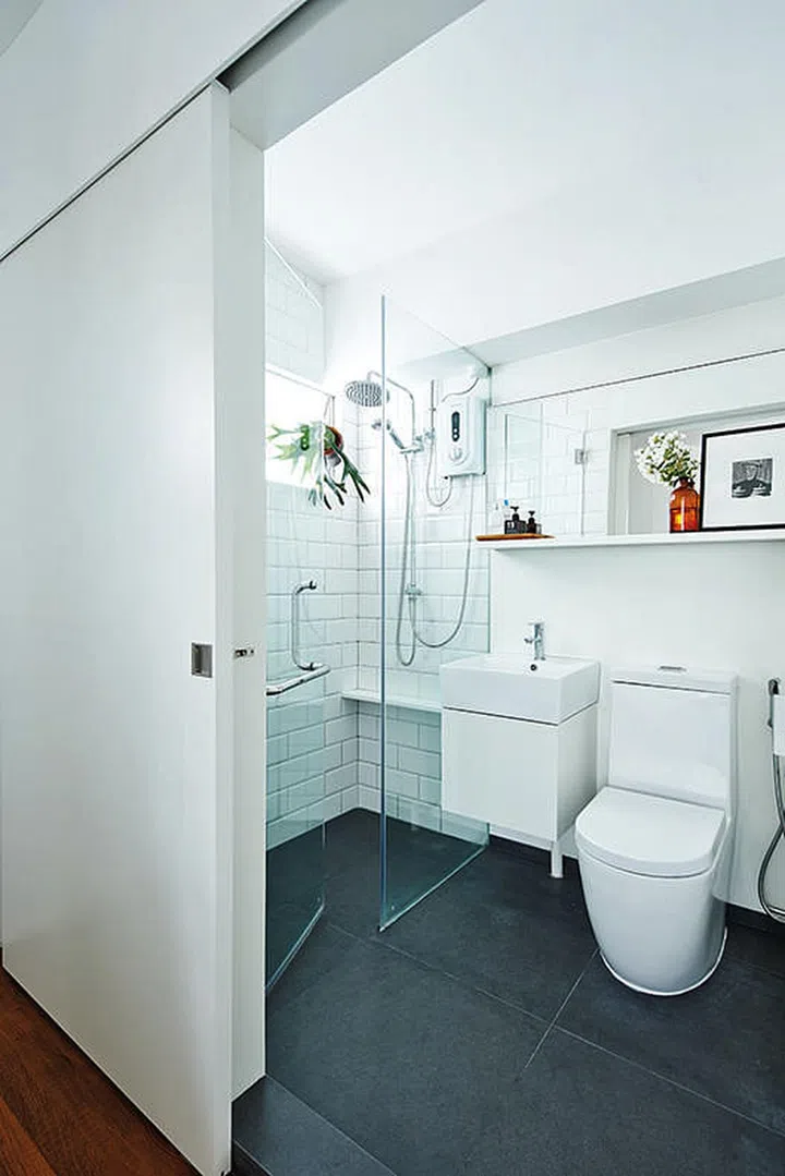 When decorating your home, don't forget the bathroom. A slim ledge like this one gives you space to display some flowers or photographs. Interior Design by J + A Design.