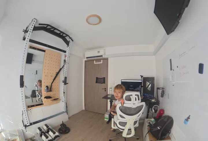 Mr Sim Kwang Wei in the home gym and study room he built himself.