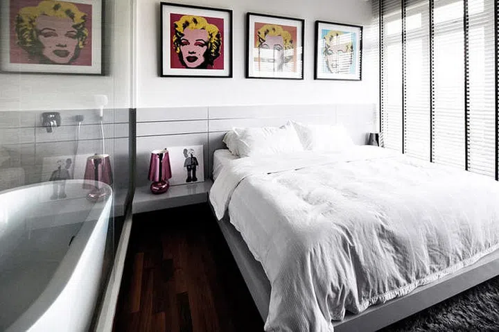 A row of Andy Warhol’s Marilyn prints adds colour to the master bedroom.