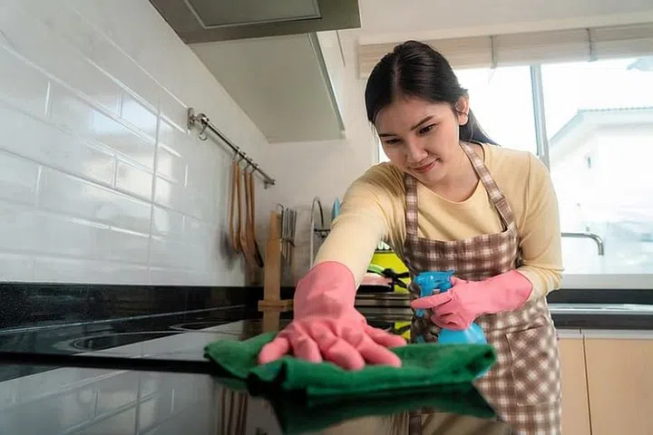 Domestic helper cleaning the kitchen