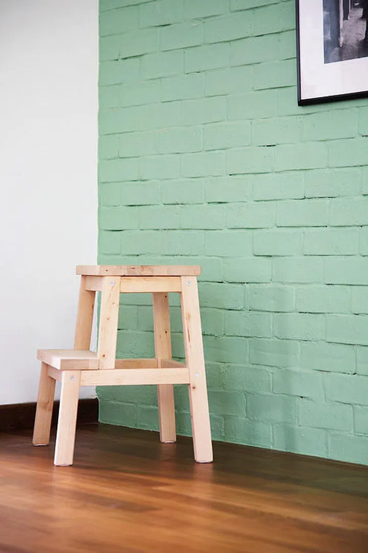 A brick wall was painted pastel green to reflect the flat’s 1940s origins.
