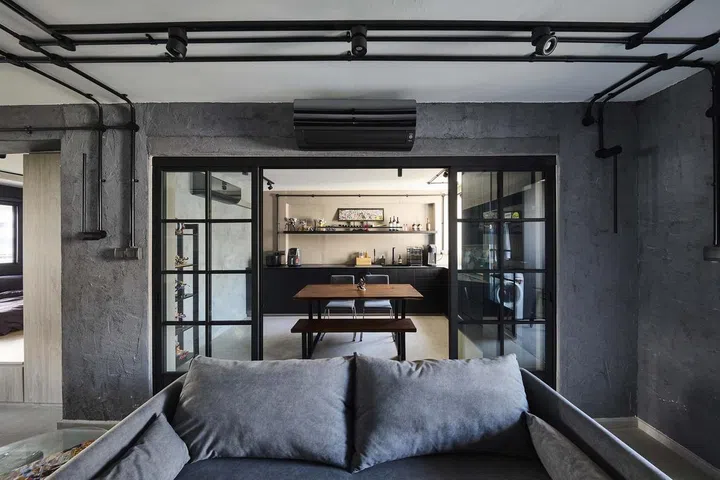 With the kitchen counter, induction cooker, sink and refrigerator arranged around the periphery, the space in the middle is freed up for a fairly sizeable dining set that can accommodate a party of up to six persons in flight attendant Kenny Shoo's 646 sq ft 3-room HDB flat at Tampines Street 41.