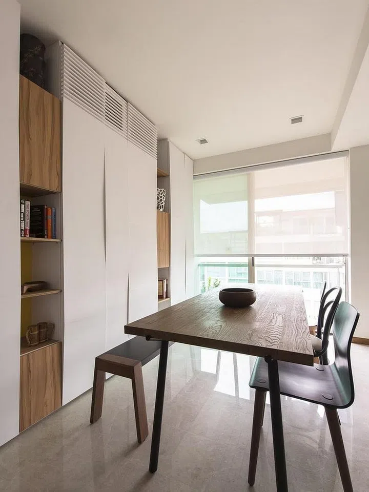 A black and dark walnut wood set of dining bench, dining table, and dining chairs. Interior design by Story of Us