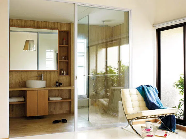 The master bedroom feels even more spacious after Karina replaced the bathroom door with a glass sliding door.