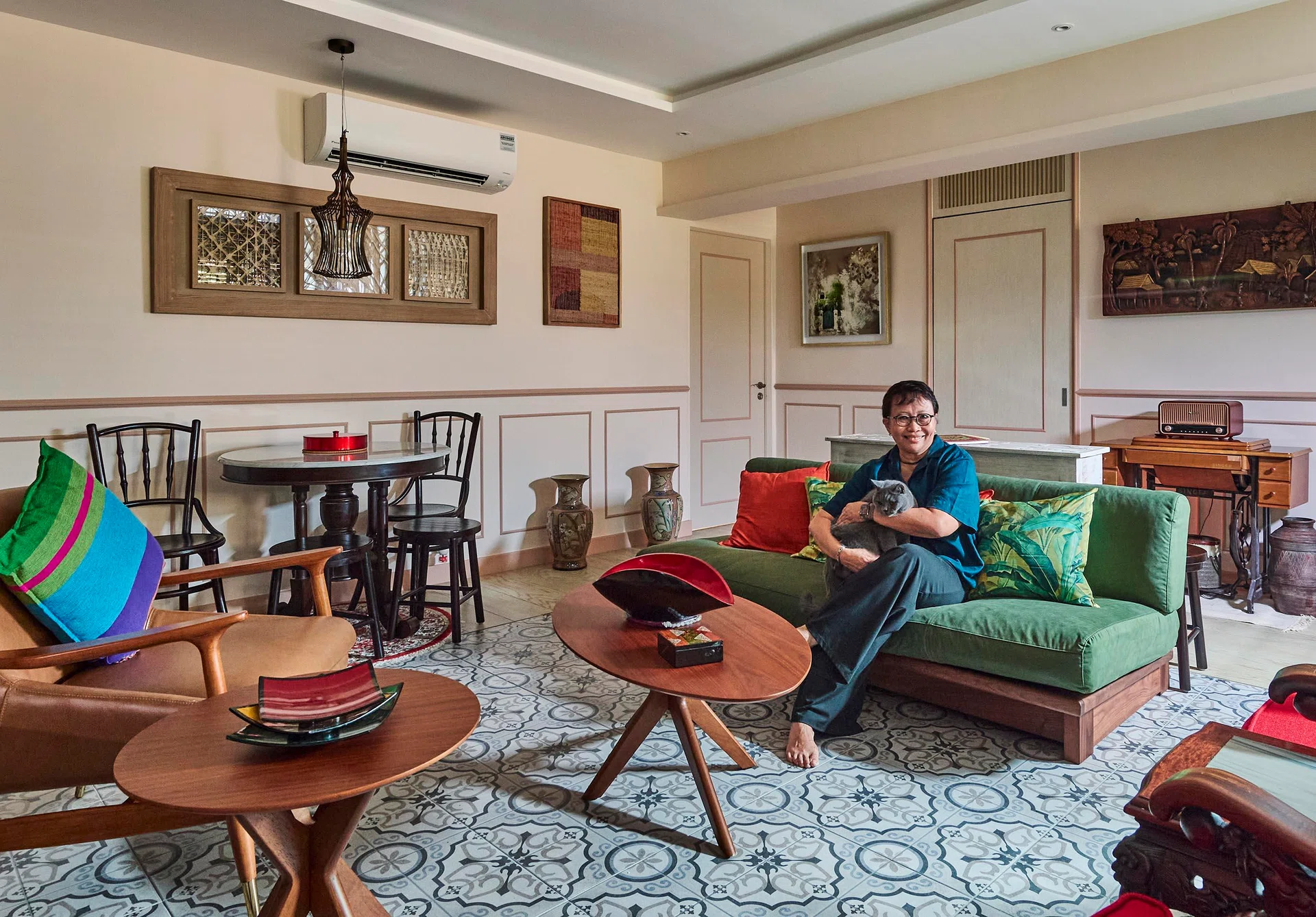 Ms Mush in her living room (4-room resale HDB flat in Sunset Way, 1,120 sq ft, designed by AR-Kee Design Studio) surrounded by keepsakes from her family and travels.