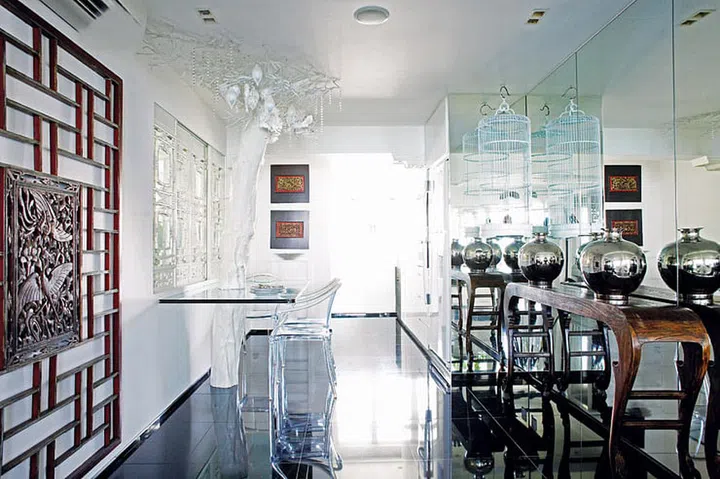 Moving the kitchen to the back room helped create a larger dining area. The reflective black flooring adds to the roomy feel.