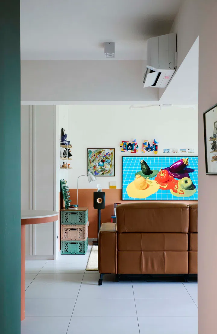 A peek into the living room from the kitchen, revealing bold colour choices and layered textures.