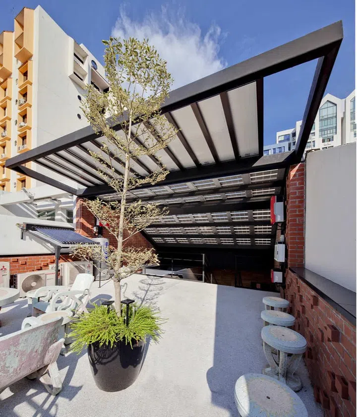 Building Integrated Photovoltaic (BIPV) panels clad the entire roof, where solar energy is harnessed.