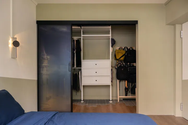 The designers carved out a compact wardrobe space, balancing storage with bedroom comfort.
