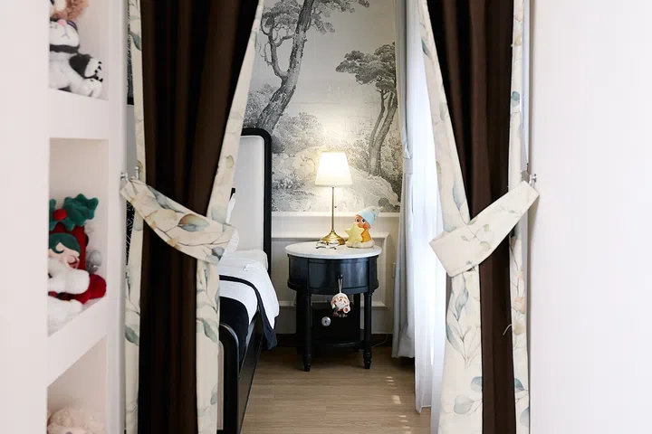 Curtains create a softer transition from the bedroom into the walk-in wardrobe.